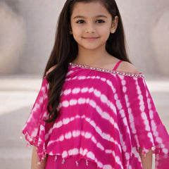 Young girl wearing a pink and white tie-dye top with a blurred background