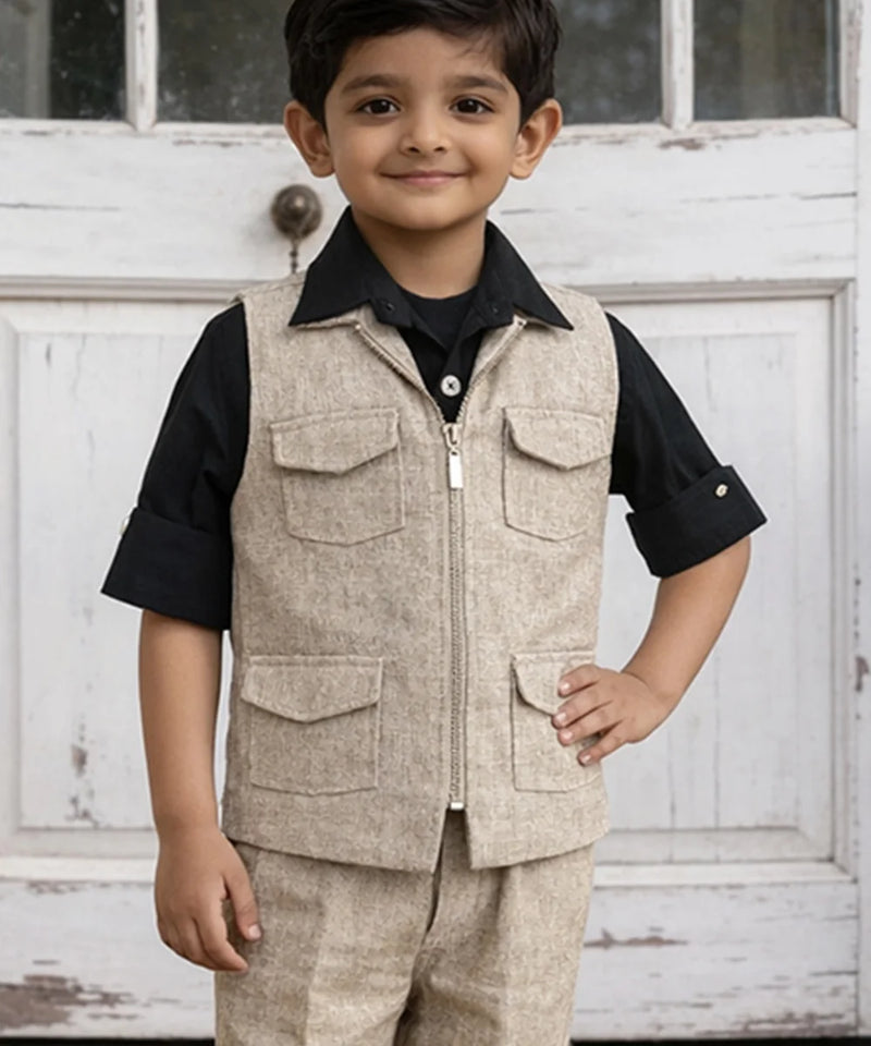 Child wearing a beige vest over a black shirt with a white door background
