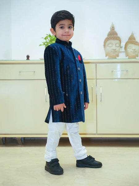 navy blue shimmer sherwani paired with white pajamas 