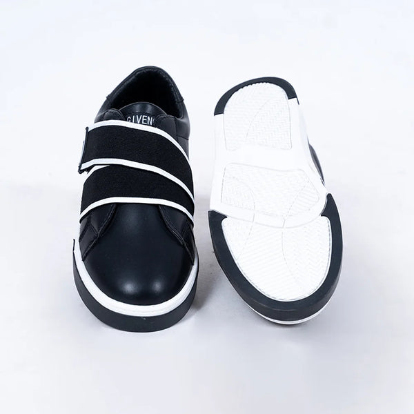 Close-up of trendy boys' black sneakers with contrasting white straps and cushioned insole, Jaipur