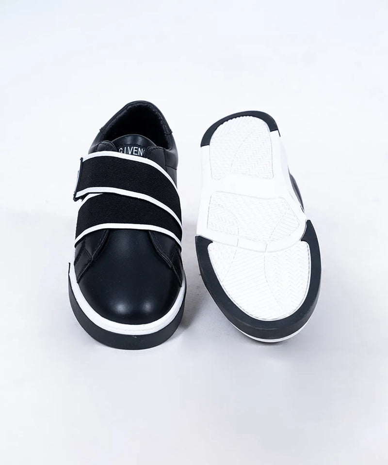 Close-up of trendy boys' black sneakers with contrasting white straps and cushioned insole, Jaipur