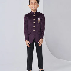 Child wearing a formal purple blazer with black pants on a white background