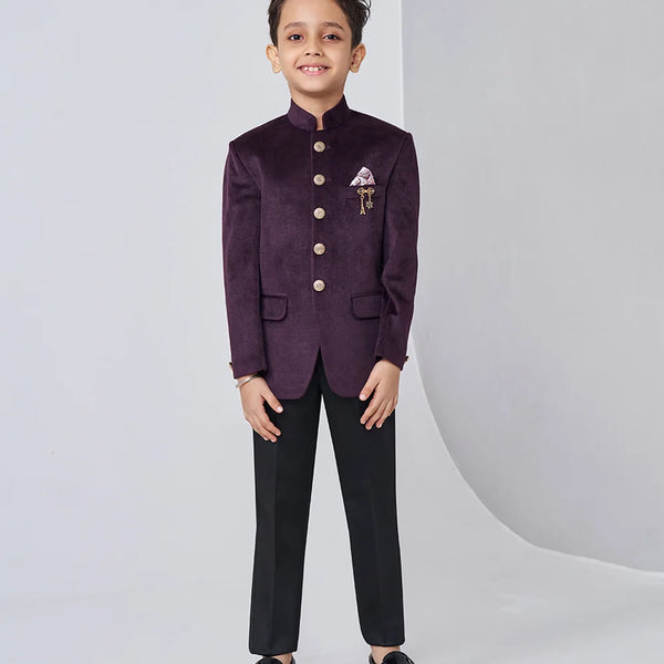 Child wearing a formal purple blazer with black pants on a white background