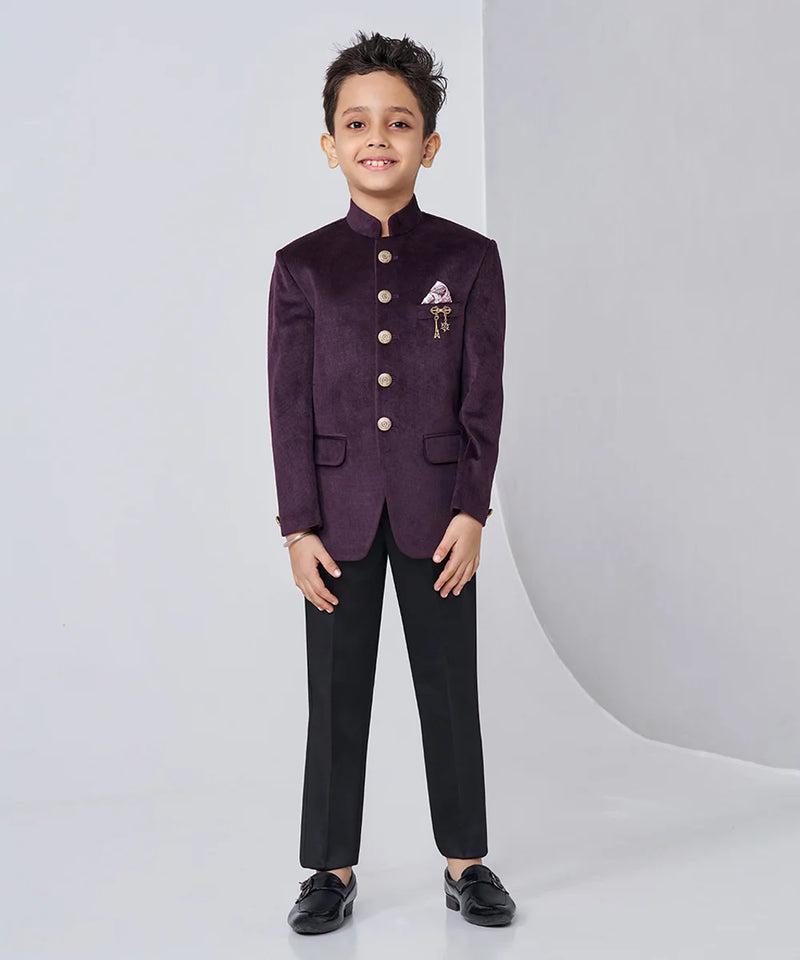 Child wearing a formal purple blazer with black pants on a white background