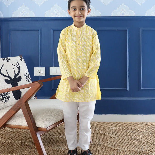 It is a light yellow Colored printed kurta teamed up with a pyjama, that has an elasticated waist. It's the best boy's designer kurta-pyjama set.