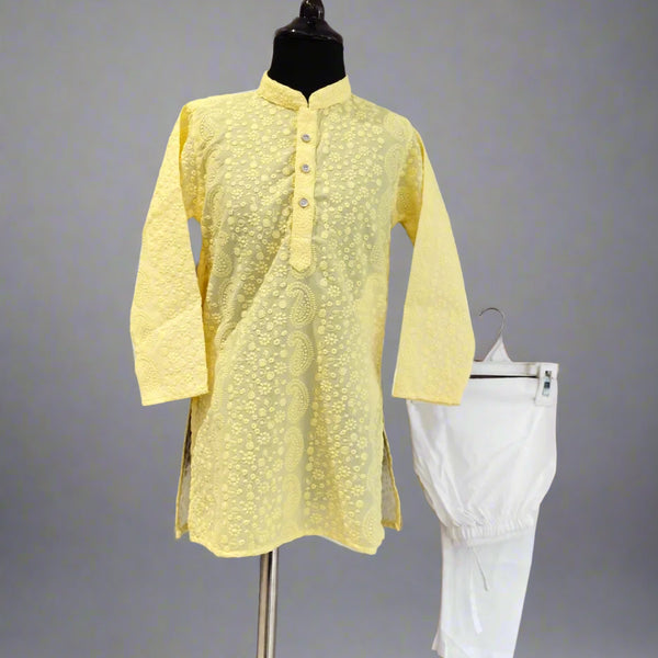 A yellow colored kurta pyjama set for kids displayed on a mannequin