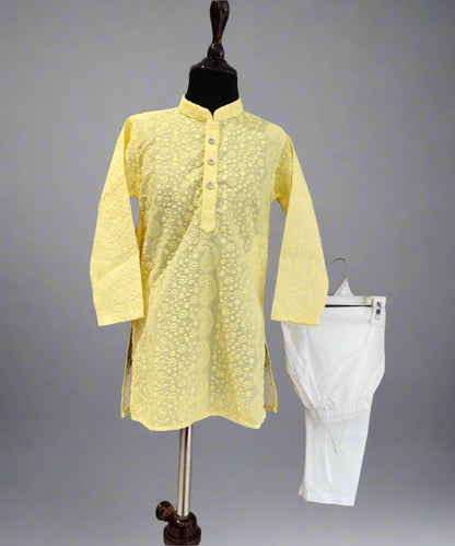A yellow colored kurta pyjama set for kids displayed on a mannequin