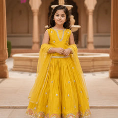 Young girl in a yellow traditional outfit standing in front of architectural background
