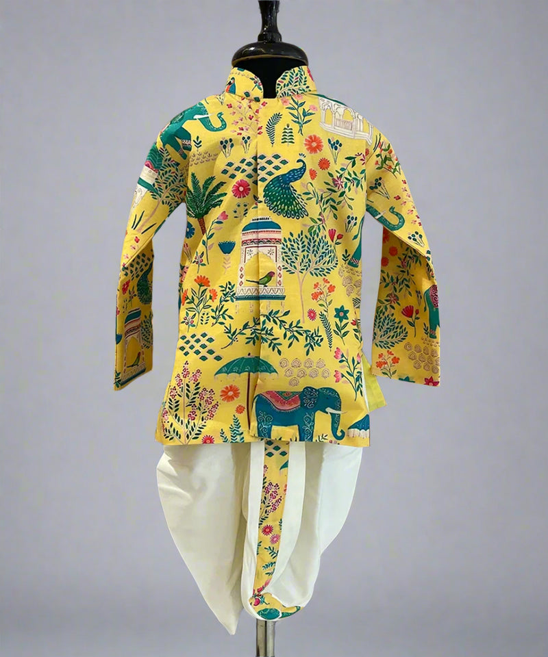 A yellow colored printed dhoti kurta set for boys displayed on a mannequin, featuring a floral and animal pattern.