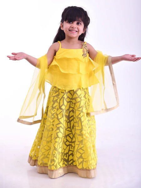 Yellow layered kids lehenga choli with floral lace, perfect for weddings in Jaipur
